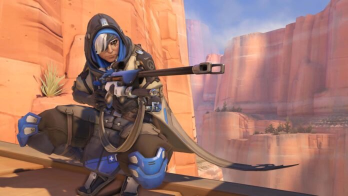 Ana is crouching on the Route 66 map in Overwatch.