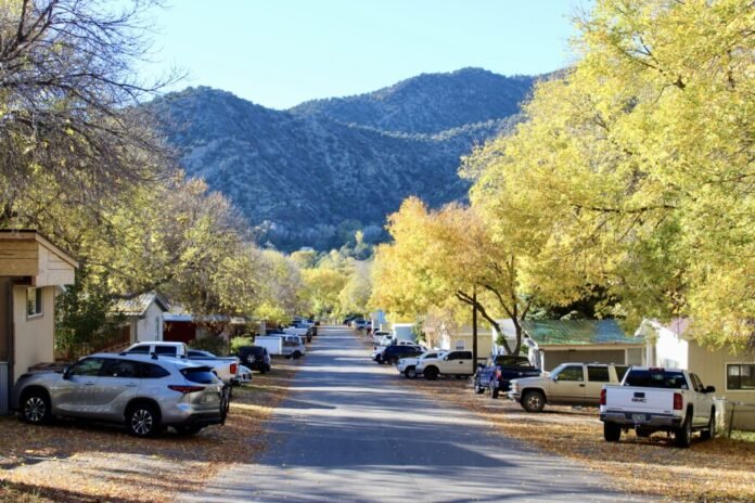 Trees line a quiet street in front of homes Wednesday at the Apple Tree mobile home park in New Castle. Water quality problems in the park have contributed to a new Colorado law that gives the state the authority to test water quality in mobile home parks and, if necessary, force owners to fix any problems.